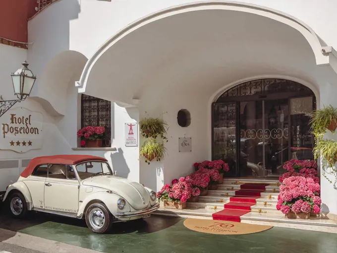 Hotel Poseidon entrance with vintage car and pink flowers