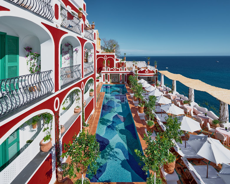 Le Sirenuse red pool exterior overlooking the sea
