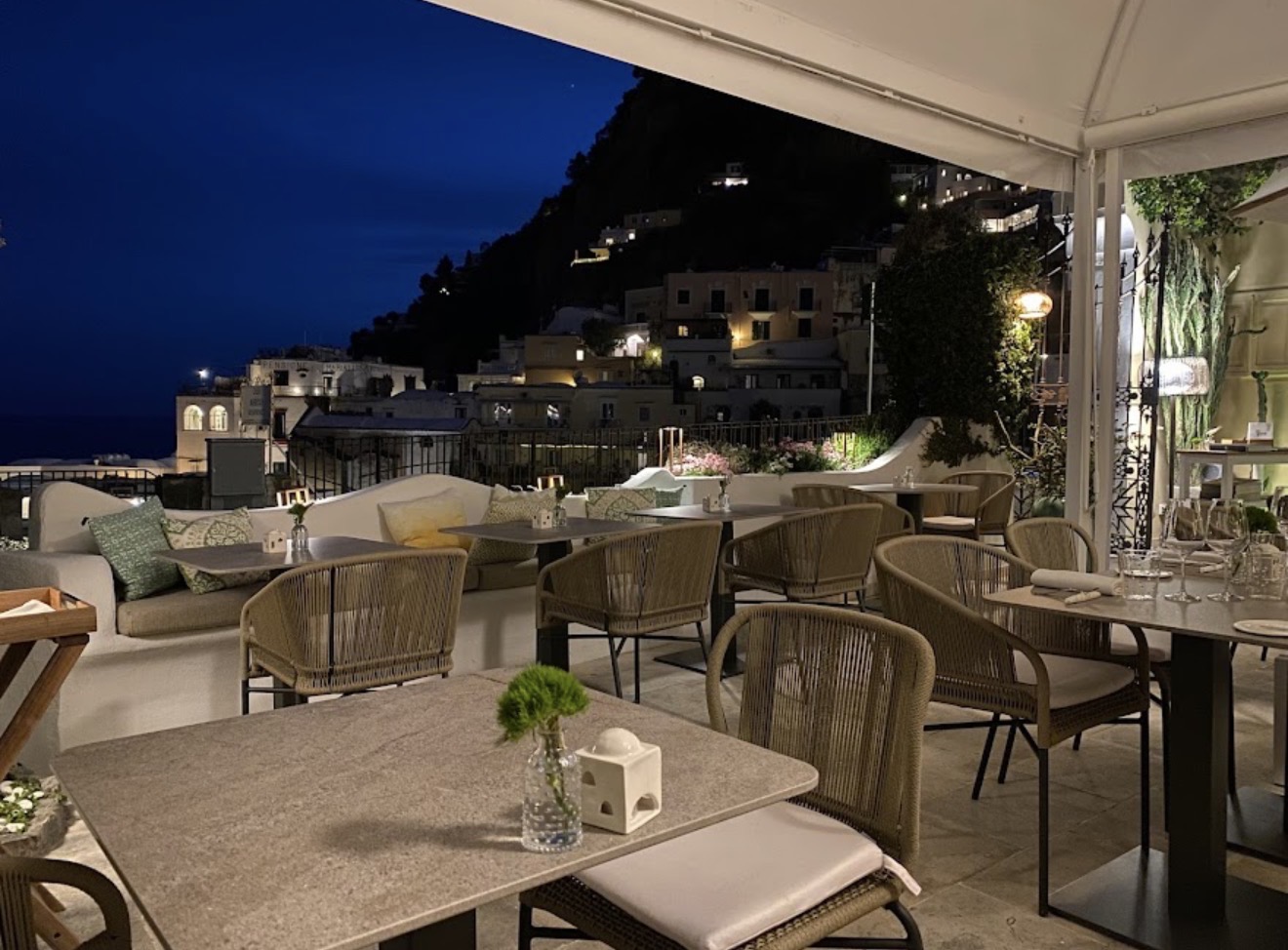 Next2 restaurant evening terrace with tables and Positano view